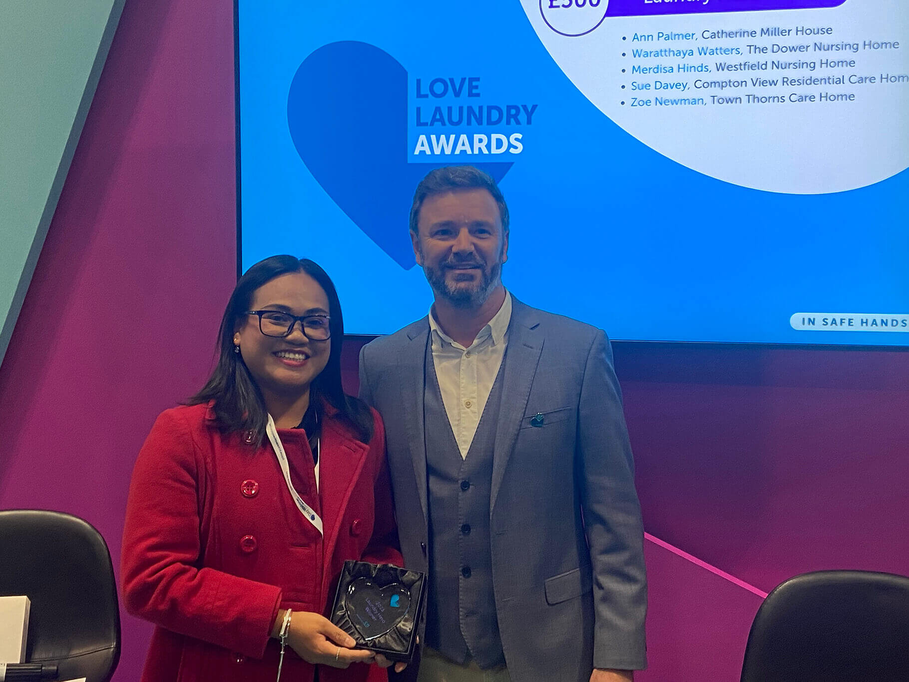 WASHCO's managing director presents Laundry hero winner with award