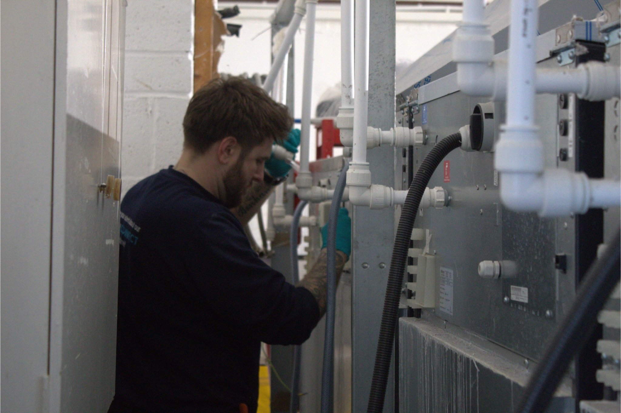 A WASHCO engineer working behind WASHING machines